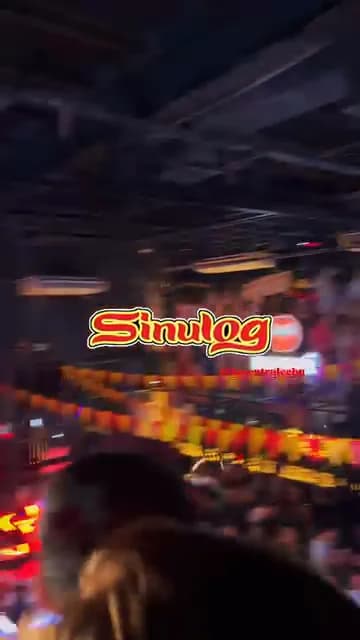 Phone footage panning across a crowd at a Sinulog nightlife event.